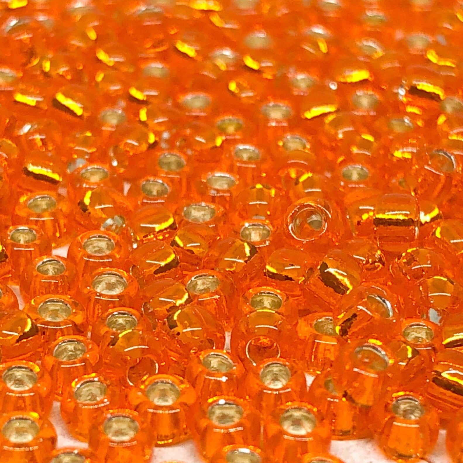 TOHO Perlen Rocaille Orange 10g, Silver Lined Hyacinth Nr. 30B