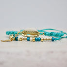Armband mit Cauri Muschel und Fisch Anhänger